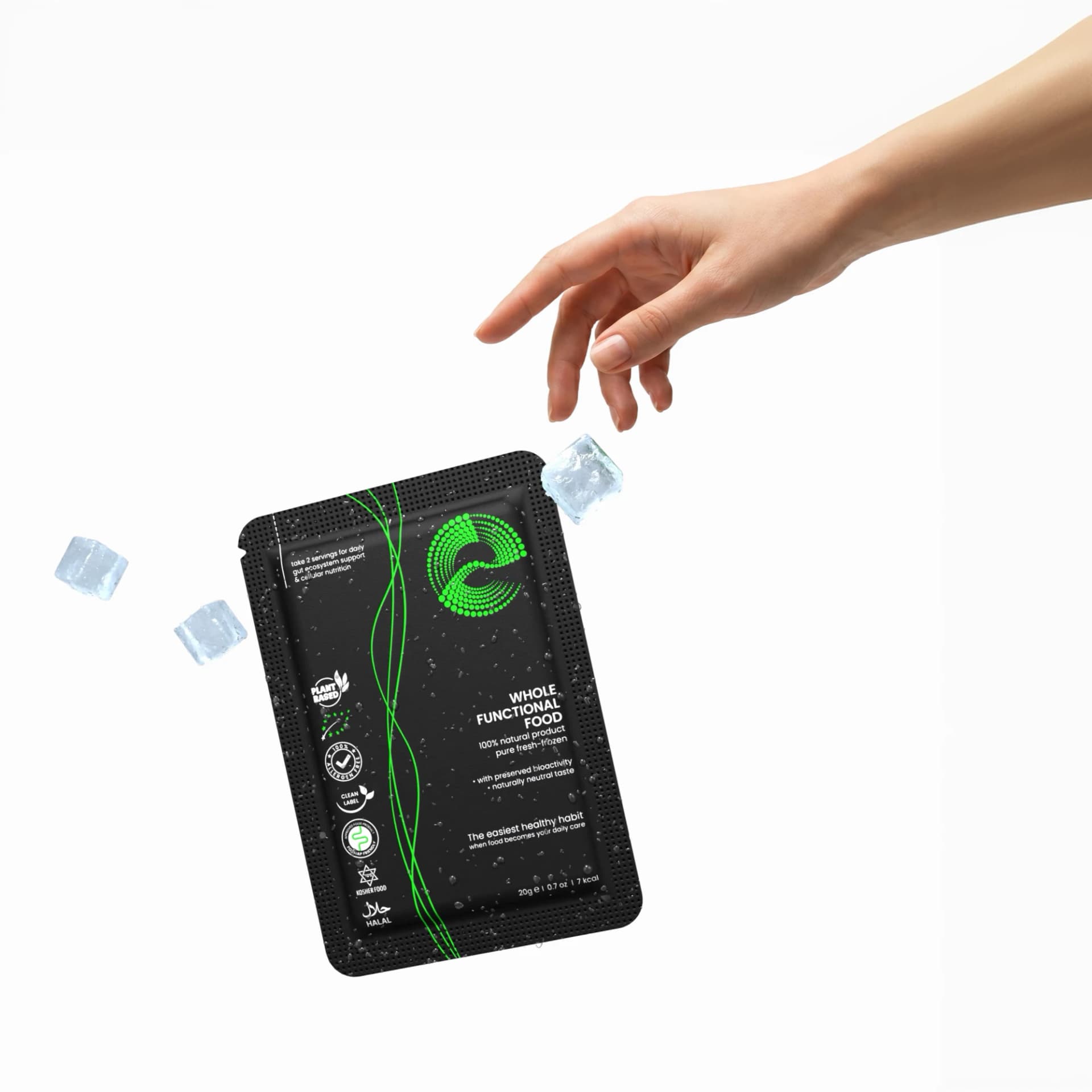A hand reaching toward a frozen Greespi sachet